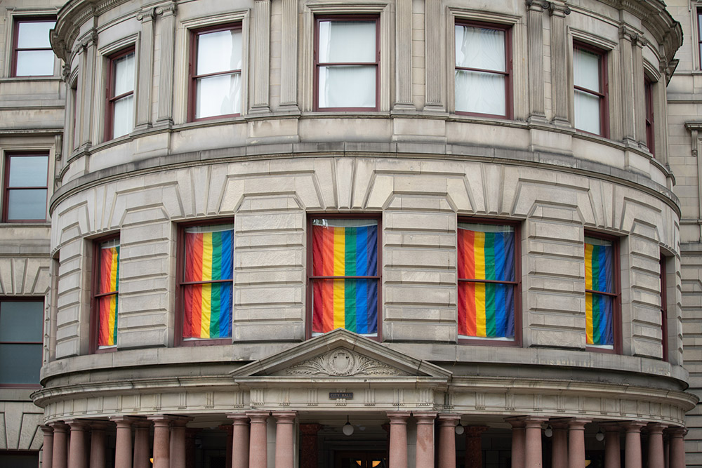 Pride flags hang in the windows of City Hall in Portland, Oregon. (Dreamstime/Alexander Oganezov)